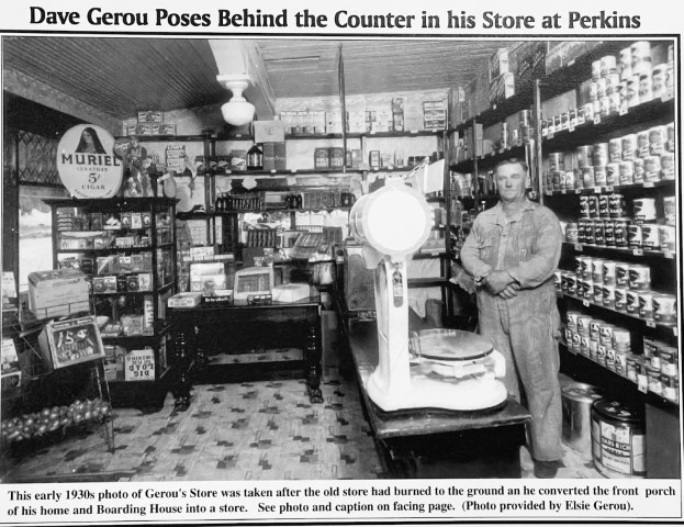 Dave Gerou Poses behind the counter in his store at Perkins. This early 1930s photo of Gerou's Store was taken after the old store had burned to the ground an he coverted the front porch of his home and Boarding House into a store. See photo caption on facing page. (Photo provided by Elsie Gerou).