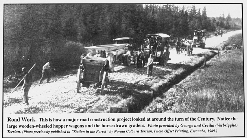 Road Work. This is how a major road construction project looked at around the turn of the Century. Notice the large wooden-wheeled hopper wagons and horse-drawn graders. Photo provided by George and Cecilia (Verbrigghe) Terrian. (Photo previously published in "Station in the Forest" by Norma Colburn Terrian, Photo Offset Printing, Escanaba, 1969.)